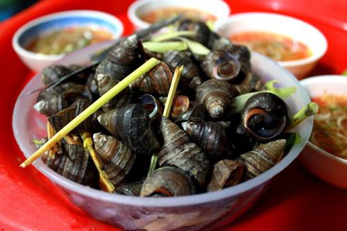 Ăn ốc nóng: Trời mưa rét là lúc những hàng ốc bán chạy nhất. Ốc Hà Nội thường được luộc cùng lá chanh, sả, rồi chấm với nước mắm pha thơm lừng, khiến thực khách không khỏi xuýt xoa. Mỗi hàng lại có một bí kíp pha nước chấm riêng, cùng nhiều món hấp dẫn như chân gà, nem chua rán, khoai chiên. Ảnh: Hoàng Nhi/Zing.
