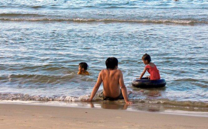 Phút giây yên bình cùng con ở bãi tắm Khe Hai - Ảnh: VÕ QUÝ CẦU