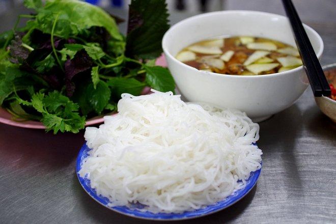 Hai thành phần không thể thiếu có của món bún chả Hà Nội chính là bún và rau sống. Bún của quán tươi sạch, ăn vào sẽ thấy độ dai mềm, đậm đà hơn khi thưởng thức cùng nước chấm chua ngọt và chả, thịt nướng còn nóng hổi. Thực khách cũng có thể gọi thêm bún với giá 5.000 đồng mỗi đĩa nếu ăn chưa "đã". Ngoài ra các loại rau sống như xà lách, kinh giới, tía tô, mùi tàu, rau mùi... sẽ góp thêm hương vị, giúp thực khách bớt cảm giác ngậy của chả, thịt và còn tăng tính mát cho món ăn. Ảnh: Hương Chi